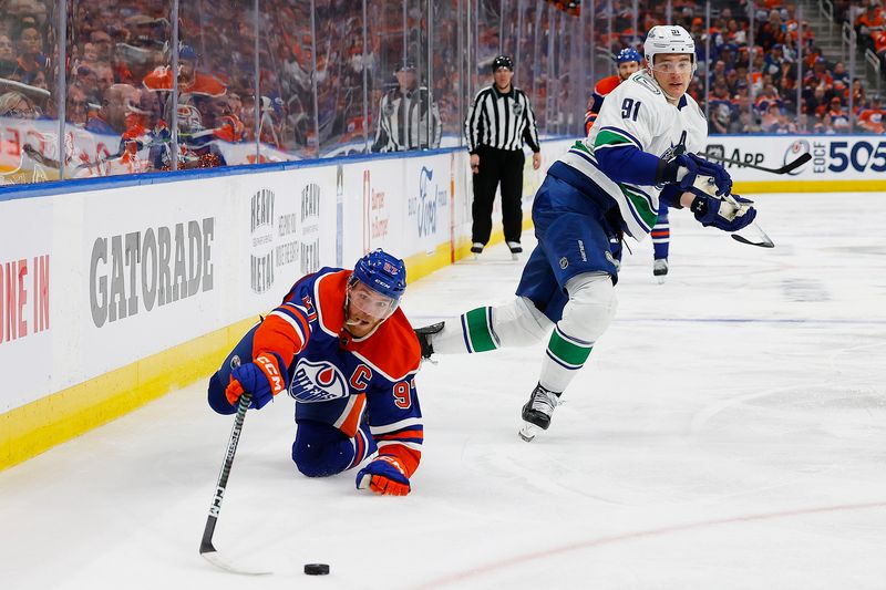 May 12, 2024; Edmonton, Alberta, CAN; Vancouver Canucks defensemen Nikita Zadorov (91) trips up Edmonton Oilers 97/ during the third period in game three of the second round of the 2024 Stanley Cup Playoffs at Rogers Place. Mandatory Credit: Perry Nelson-USA TODAY Sports