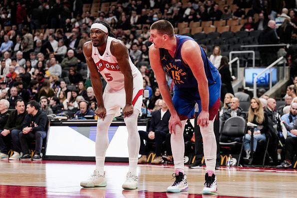 TORONTO, ON - DECEMBER 20: Precious Achiuwa #5 of the Toronto Raptors and Nikola Jokic #15 of the Denver Nuggets look on before a free throw during the second half at Scotiabank Arena on December 20, 2023 in Toronto, Ontario, Canada. NOTE TO USER: User expressly acknowledges and agrees that, by downloading and/or using this Photograph, user is consenting to the terms and conditions of the Getty Images License Agreement. (Photo by Andrew Lahodynskyj/Getty Images)