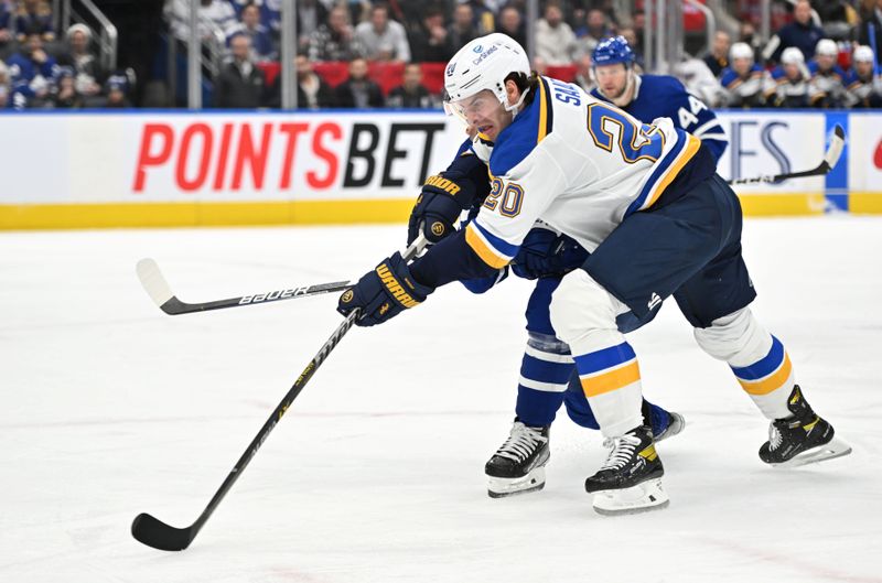Jan 3, 2023; Toronto, Ontario, CAN; St. Louis Blues forward Brandon Saad (20) shoots the puck against the Toronto Maple Leafs in the second period at Scotiabank Arena. Mandatory Credit: Dan Hamilton-USA TODAY Sports
