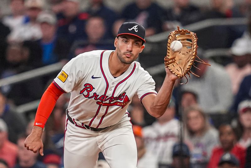 Apr 23, 2024; Cumberland, Georgia, USA; Atlanta Braves first base Matt Olson (28) records an out against Miami Marlins outfielder Bryan De La Cruz (14) (not shown) during the ninth inning at Truist Park. Mandatory Credit: Dale Zanine-USA TODAY Sports