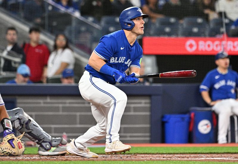 Apr 13, 2024; Toronto, Ontario, CAN;  Toronto Blue Jays center fielder Daulton Varsho (25) hits a grand slam home run against the Colorodo Rockies in the first inning at Rogers Centre. Mandatory Credit: Dan Hamilton-USA TODAY Sports