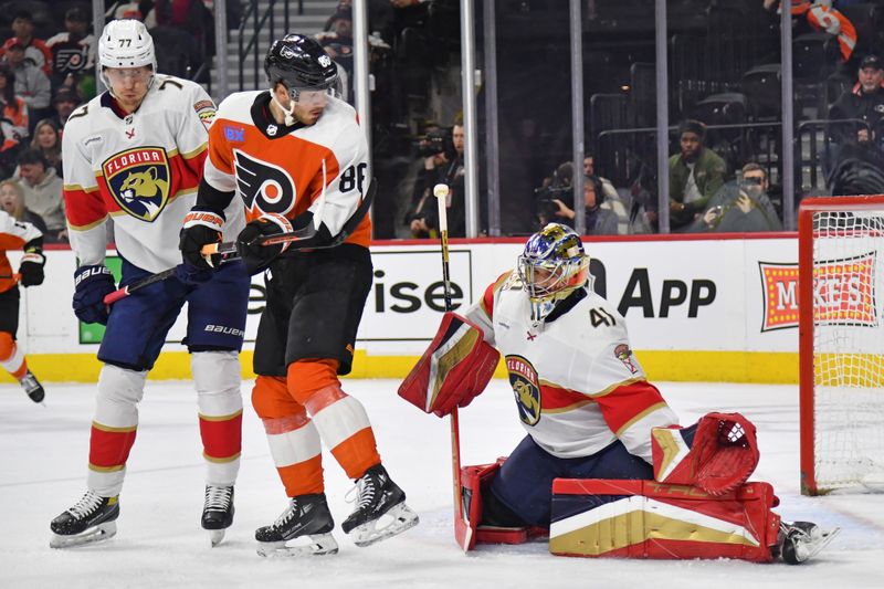 Mar 24, 2024; Philadelphia, Pennsylvania, USA; Philadelphia Flyers left wing Joel Farabee (86) battles with Florida Panthers defenseman Niko Mikkola (77) and goaltender Anthony Stolarz (41) during the first period at Wells Fargo Center. Mandatory Credit: Eric Hartline-USA TODAY Sports