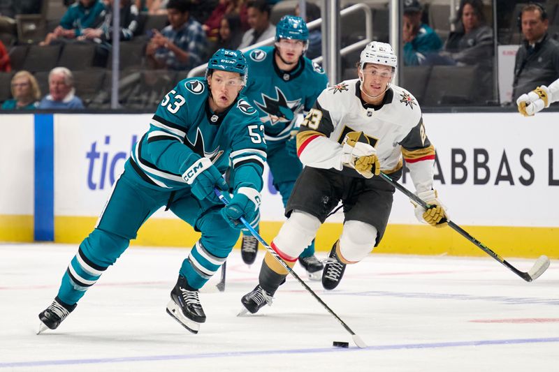 Sep 21, 2025; San Jose, California, USA; San Jose Sharks left wing Jeff Skinner (53) plays the puck against Vegas Golden Knights left wing Cole Reinhardt (23) during the first period at SAP Center at San Jose. Mandatory Credit: Robert Edwards-Imagn Images