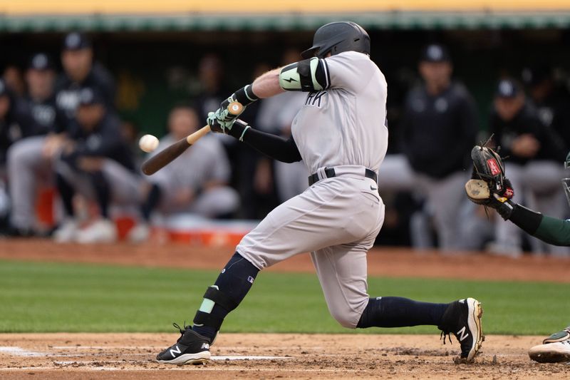 Jun 28, 2023; Oakland, California, USA;  New York Yankees center fielder Harrison Bader (22) hits a double during the fourth inning against the Oakland Athletics at Oakland-Alameda County Coliseum. Mandatory Credit: Stan Szeto-USA TODAY Sports