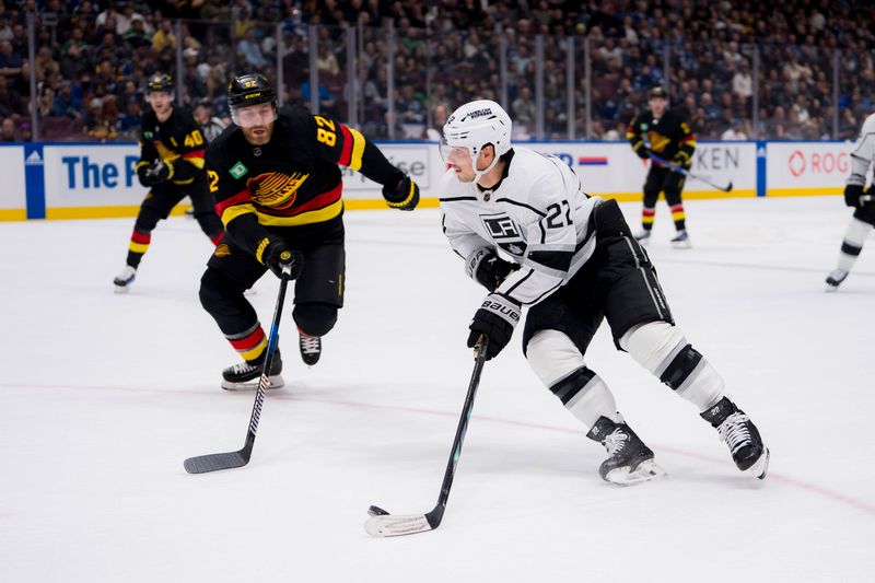 Feb 29, 2024; Vancouver, British Columbia, CAN; Los Angeles Kings forward Kevin Fiala (22) drives past Vancouver Canucks defenseman Ian Cole (82) in the first period at Rogers Arena. Mandatory Credit: Bob Frid-USA TODAY Sports