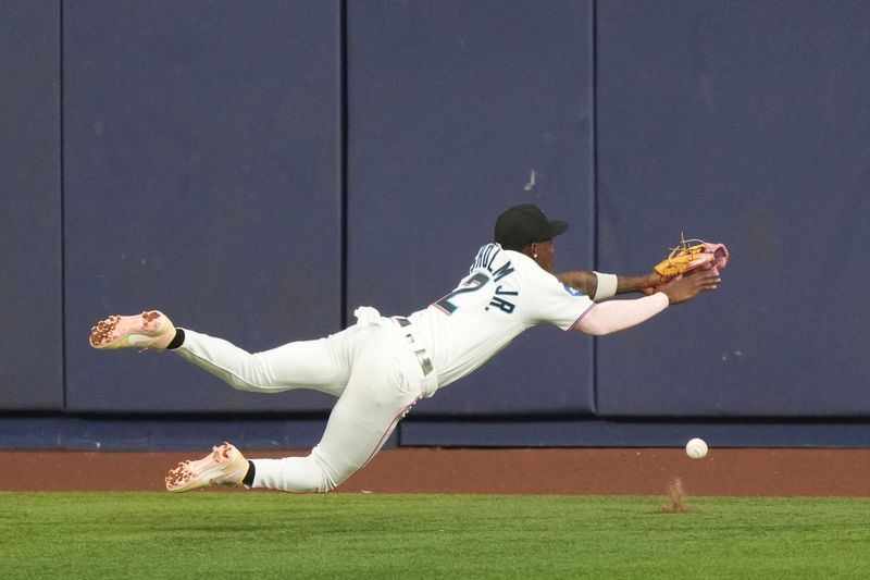 Sep 20, 2023; Miami, Florida, USA;  Miami Marlins center fielder Jazz Chisholm Jr. (2) dives for a fly ball in the fourth inning against the New York Mets at loanDepot Park. Mandatory Credit: Jim Rassol-USA TODAY Sports