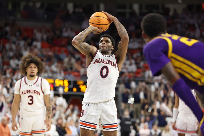 Jan 13, 2024; Auburn, Alabama, USA; Auburn Tigers guard K.D. Johnson (0) attempts a free throw against the LSU Tigers during the second half at Neville Arena. Mandatory Credit: John Reed-USA TODAY Sports