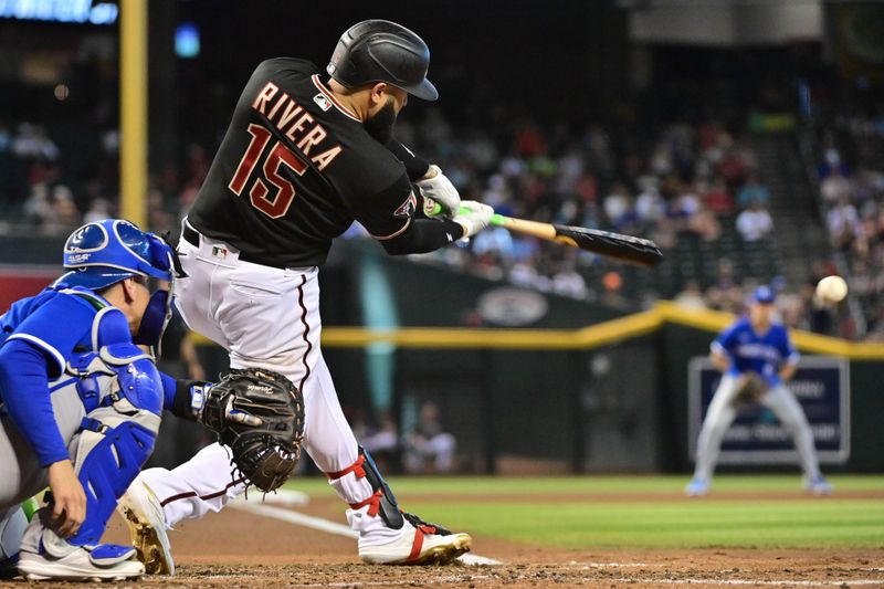 Apr 26, 2023; Phoenix, Arizona, USA; Arizona Diamondbacks third baseman Emmanuel Rivera (15) singles in the fourth inning against the Kansas City Royals at Chase Field. Mandatory Credit: Matt Kartozian-USA TODAY Sports