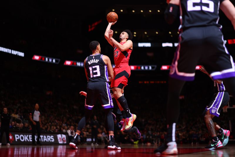 TORONTO, CANADA - MARCH 20: Jordan Nwora #13 of the Toronto Raptors drives to the basket during the game against the Sacramento Kings on March 20, 2024 at the Scotiabank Arena in Toronto, Ontario, Canada.  NOTE TO USER: User expressly acknowledges and agrees that, by downloading and or using this Photograph, user is consenting to the terms and conditions of the Getty Images License Agreement.  Mandatory Copyright Notice: Copyright 2024 NBAE (Photo by Vaughn Ridley/NBAE via Getty Images)