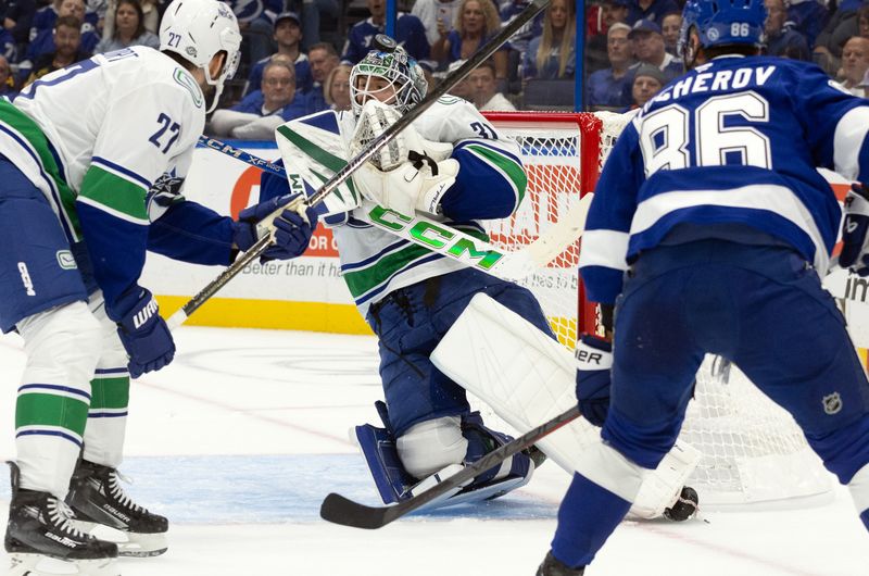 Oct 15, 2024; Tampa, Florida, USA; Vancouver Canucks goaltender Arturs Silovs (31) makes a save against the Tampa Bay Lightning during the first period at Amalie Arena. Mandatory Credit: Kim Klement Neitzel-Imagn Images