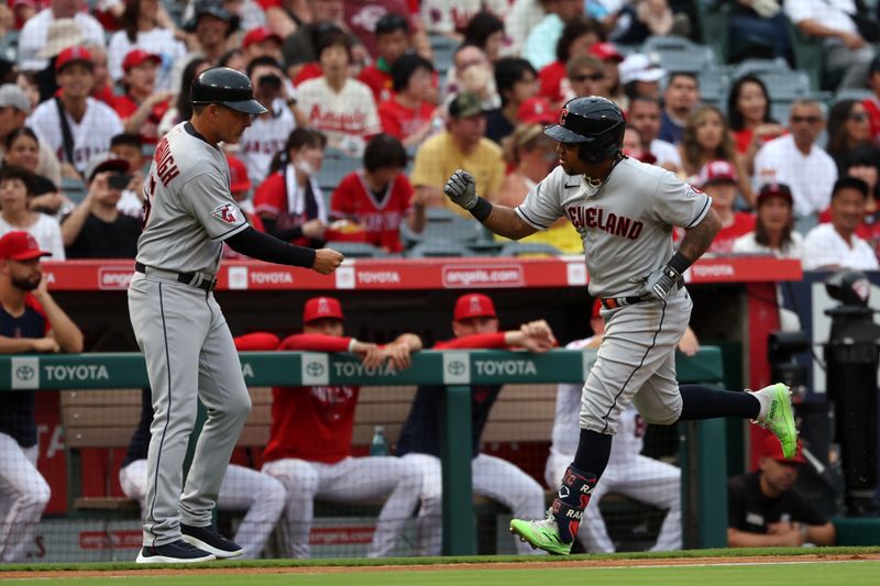 Sep 9, 2023; Anaheim, California, USA;  Cleveland Guardians designated hitter Jose Ramirez (11) is greeted by third base coach Mike Sarbaugh (16) after hitting a home run during the first inning against the Los Angeles Angels at Angel Stadium. Mandatory Credit: Kiyoshi Mio-USA TODAY Sports