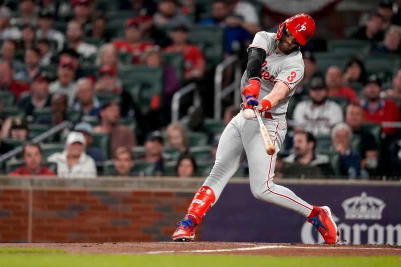 Oct 12, 2022; Atlanta, Georgia, USA; Philadelphia Phillies designated hitter Bryce Harper (3) hits a double against the Atlanta Braves in the second inning during game two of the NLDS for the 2022 MLB Playoffs at Truist Park. Mandatory Credit: Dale Zanine-USA TODAY Sports