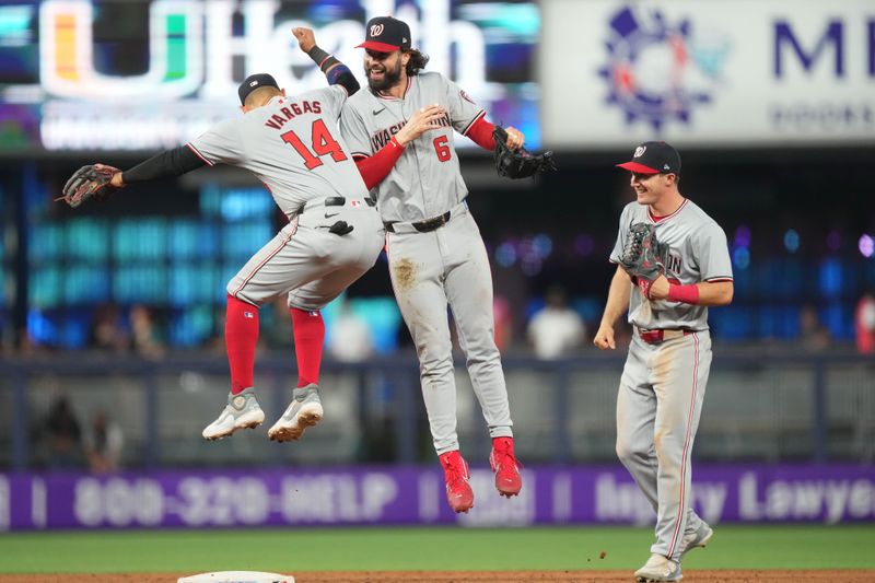 Apr 28, 2024; Miami, Florida, USA;  Washington Nationals left fielder Jesse Winker (6) and second base Ildemaro Vargas (14) celebrate a victory over the Miami Marlins as center fielder Jacob Young (30) looks on at loanDepot Park. Mandatory Credit: Jim Rassol-USA TODAY Sports