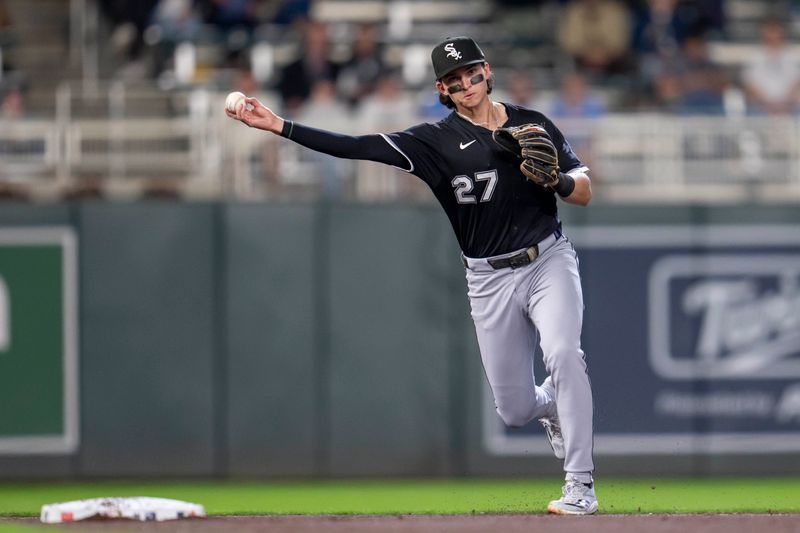 Apr 22, 2025; Minneapolis, Minnesota, USA; Chicago White Sox right fielder Brooks Baldwin (27) throws the ball to first base for an out in the eighth inning against the Minnesota Twins at Target Field. Mandatory Credit: Jesse Johnson-Imagn Images