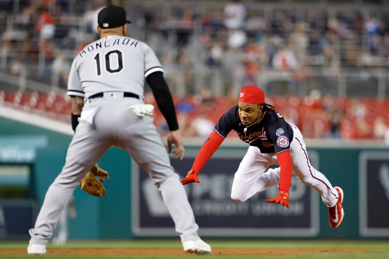 Sep 19, 2023; Washington, District of Columbia, USA; Washington Nationals shortstop CJ Abrams (5) dives into third base with a triple ahead of a tag by Chicago White Sox third baseman Yoan Moncada (10) during the first inning at Nationals Park. Mandatory Credit: Geoff Burke-USA TODAY Sports