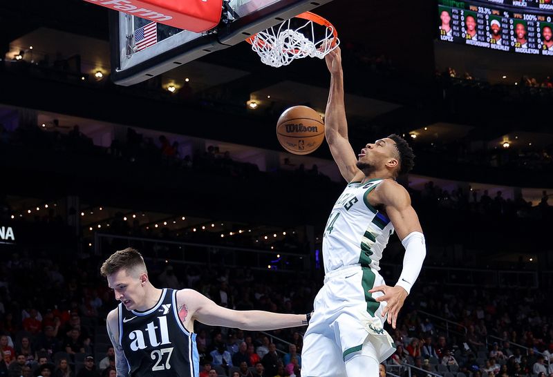 ATLANTA, GEORGIA - MARCH 30:  Giannis Antetokounmpo #34 of the Milwaukee Bucks dunks against Vit Krejci #27 of the Atlanta Hawks during the first quarter at State Farm Arena on March 30, 2024 in Atlanta, Georgia.  NOTE TO USER: User expressly acknowledges and agrees that, by downloading and/or using this photograph, user is consenting to the terms and conditions of the Getty Images License Agreement.  (Photo by Kevin C. Cox/Getty Images)