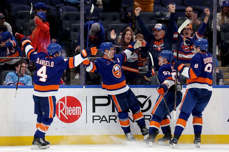 Mar 20, 2025; Elmont, New York, USA; New York Islanders center Bo Horvat (14) celebrates his game winning goal against the Montreal Canadiens with center Casey Cizikas (53) and defensemen Noah Dobson (8) and Tony DeAngelo (4) during overtime at UBS Arena. Mandatory Credit: Brad Penner-Imagn Images