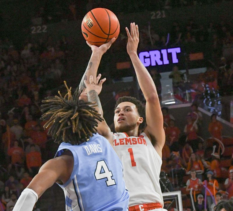 Jan 6, 2024; Clemson, South Carolina, USA; Clemson senior guard Chase Hunter (1) shoots near University of North Carolina guard RJ Davis (4) during the second half at Littlejohn Coliseum. Mandatory Credit: Ken Ruinard-USA TODAY Sports