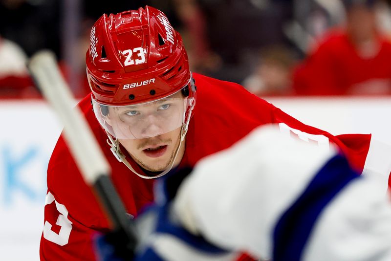 Jan 25, 2025; Detroit, Michigan, USA;  Detroit Red Wings left wing Lucas Raymond (23) gets set during a face off in the second period against the Tampa Bay Lightning at Little Caesars Arena. Mandatory Credit: Rick Osentoski-Imagn Images