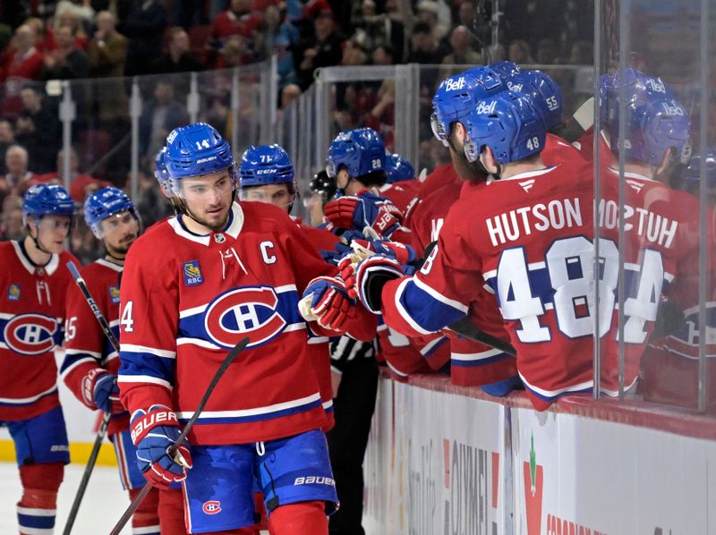 Apr 8, 2025; Montreal, Quebec, CAN; Montreal Canadiens forward Nick Suzuki (14) celebrates with teammates after scoring a goal against the Detroit Red Wings during the third period at the Bell Centre. Mandatory Credit: Eric Bolte-Imagn Images