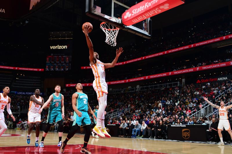 ATLANTA, GA - MARCH 23: De'Andre Hunter #12 of the Atlanta Hawks drives to the basket during the game against the Charlotte Hornets on March 23, 2024 at State Farm Arena in Atlanta, Georgia.  NOTE TO USER: User expressly acknowledges and agrees that, by downloading and/or using this Photograph, user is consenting to the terms and conditions of the Getty Images License Agreement. Mandatory Copyright Notice: Copyright 2024 NBAE (Photo by Scott Cunningham/NBAE via Getty Images)