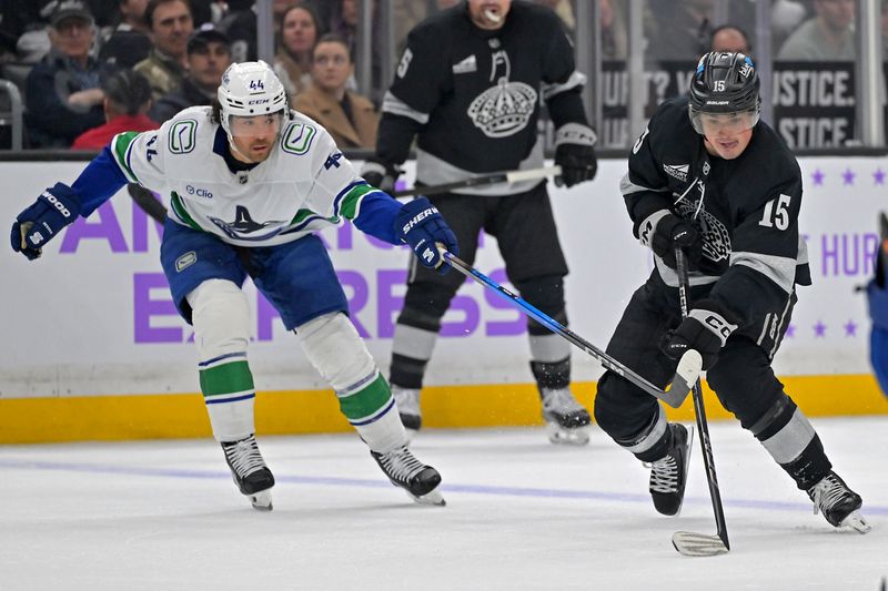 Nov 29, 2025; Los Angeles, California, USA; Vancouver Canucks left wing Kiefer Sherwood (44) defends Los Angeles Kings center Alex Turcotte (15) during the second period at Crypto.com Arena. Mandatory Credit: Jayne Kamin-Oncea-Imagn Images