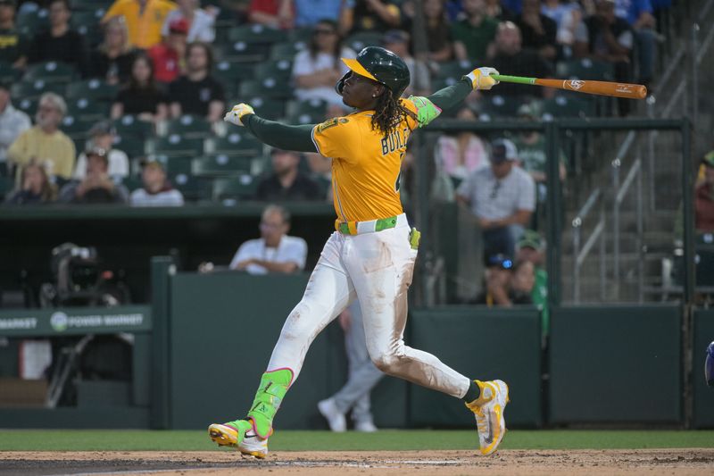 Apr 22, 2025; West Sacramento, California, USA; Athletics outfielder Lawrence Butler (4) hits a home run against the Texas Rangers during the third inning at Sutter Health Park. Mandatory Credit: Ed Szczepanski-Imagn Images