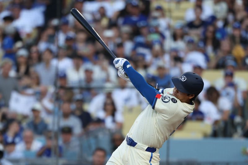Aug 9, 2025; Los Angeles, California, USA; Los Angeles Dodgers two-way player Shohei Ohtani (17) hits a single against the Toronto Blue Jays during the third inning at Dodger Stadium. Mandatory Credit: Kiyoshi Mio-Imagn Images