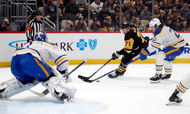 Jan 6, 2024; Pittsburgh, Pennsylvania, USA;  Pittsburgh Penguins center Evgeni Malkin (71) skates in against Buffalo Sabres goaltender Ukko-Pekka Luukkonen (1) and defenseman Owen Power (25) during the first period at PPG Paints Arena. Mandatory Credit: Charles LeClaire-USA TODAY Sports