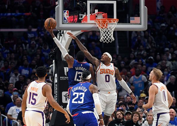 LOS ANGELES, CA - OCTOBER 23: Torrey Craig #0 of the Phoenix Suns attempts to block a layup by Paul George #13 of the Los Angeles Clippers during the second half at Crypto.com Arena on October 23, 2022 in Los Angeles, California. NOTE TO USER: User expressly acknowledges and agrees that, by downloading and or using this photograph, User is consenting to the terms and conditions of the Getty Images License Agreement. (Photo by Kevork Djansezian/Getty Images)