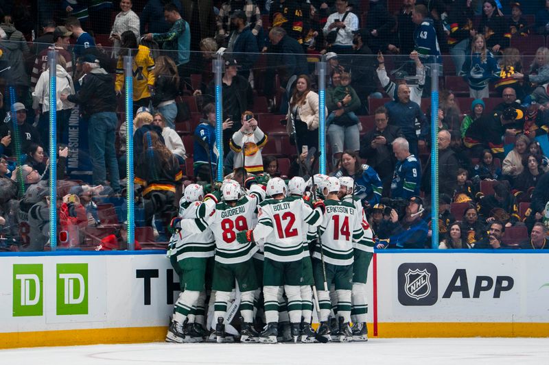 Apr 12, 2025; Vancouver, British Columbia, CAN; The Minnesota Wild celebrate their victory against against the Vancouver Canucks in overtime at Rogers Arena. Mandatory Credit: Bob Frid-Imagn Images