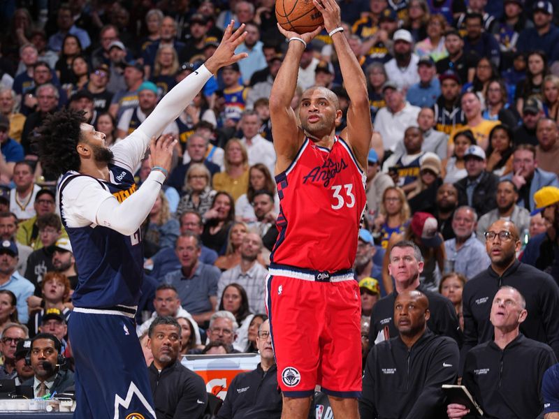 DENVER, CO - APRIL 21: Nicolas Batum #33 of the LA Clippers shoots a three point basket during Round One Game Two of the 2025 NBA Playoffs against the Denver Nuggets on April 21, 2025 at Ball Arena in Denver, Colorado. NOTE TO USER: User expressly acknowledges and agrees that, by downloading and/or using this Photograph, user is consenting to the terms and conditions of the Getty Images License Agreement. Mandatory Copyright Notice: Copyright 2025 NBAE (Photo by Bart Young/NBAE via Getty Images)