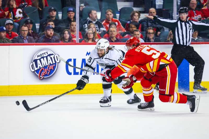 Mar 28, 2023; Calgary, Alberta, CAN; Los Angeles Kings left wing Alex Iafallo (19) and Calgary Flames defenseman Troy Stecher (51) battle for the puck during the first period at Scotiabank Saddledome. Mandatory Credit: Sergei Belski-USA TODAY Sports