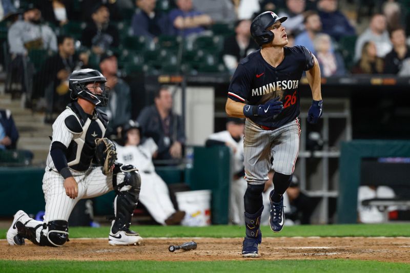 Apr 30, 2024; Chicago, Illinois, USA; Minnesota Twins outfielder Max Kepler (26) watches his RBI-sacrifice fly against the Chicago White Sox during the ninth inning at Guaranteed Rate Field. Mandatory Credit: Kamil Krzaczynski-USA TODAY Sports