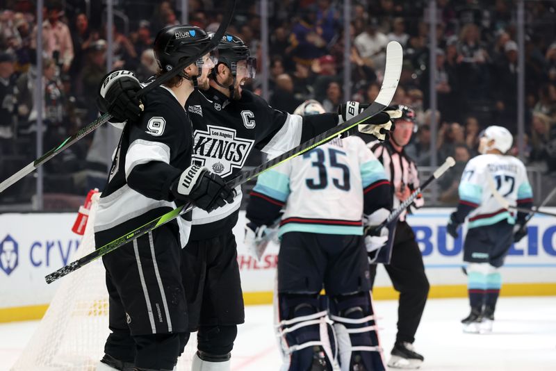 Nov 23, 2024; Los Angeles, California, USA;  Los Angeles Kings right wing Adrian Kempe (9) celebrates with center Anze Kopitar (11) after scoring a goal during the second period against the Seattle Kraken at Crypto.com Arena. Mandatory Credit: Kiyoshi Mio-Imagn Images