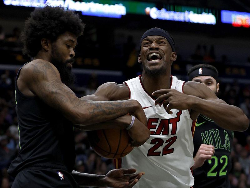 NEW ORLEANS, LOUISIANA - FEBRUARY 23: Naji Marshall #8 of the New Orleans Pelicans and Jimmy Butler #22 of the Miami Heat contend for a loose ball during the third quarter of an NBA game at Smoothie King Center on February 23, 2024 in New Orleans, Louisiana. NOTE TO USER: User expressly acknowledges and agrees that, by downloading and or using this photograph, User is consenting to the terms and conditions of the Getty Images License Agreement. (Photo by Sean Gardner/Getty Images)