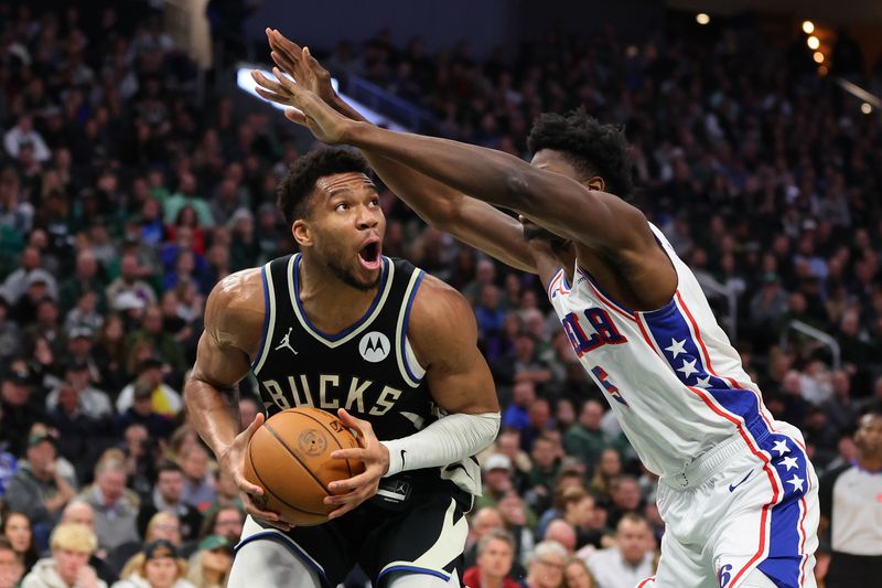 MILWAUKEE, WISCONSIN - MARCH 14: Giannis Antetokounmpo #34 of the Milwaukee Bucks is defended by Mo Bamba #5 of the Philadelphia 76ers during the first half of a game at Fiserv Forum on March 14, 2024 in Milwaukee, Wisconsin. NOTE TO USER: User expressly acknowledges and agrees that, by downloading and or using this photograph, User is consenting to the terms and conditions of the Getty Images License Agreement. (Photo by Stacy Revere/Getty Images)