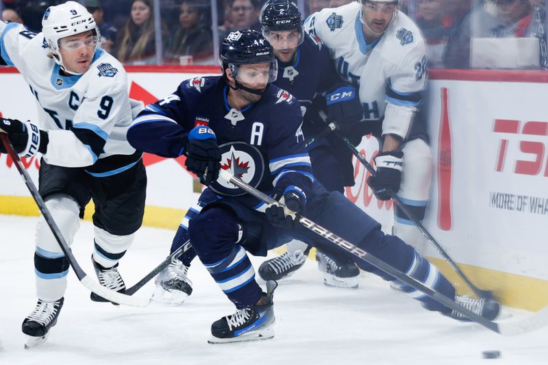 Nov 5, 2024; Winnipeg, Manitoba, CAN;  Winnipeg Jets defenseman Josh Morrissey (44) shields the puck from Utah Hockey Club forward Clayton Keller (9) during the first period at Canada Life Centre. Mandatory Credit: Terrence Lee-Imagn Images