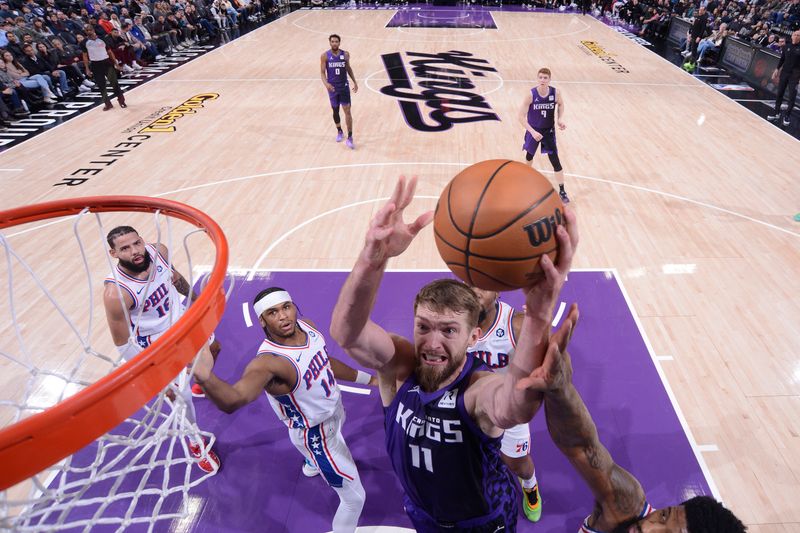 SACRAMENTO, CA - JANUARY 1:  Domantas Sabonis #11 of the Sacramento Kings drives to the basket during the game against the Philadelphia 76ers on January 1, 2025 at Golden 1 Center in Sacramento, California. NOTE TO USER: User expressly acknowledges and agrees that, by downloading and or using this Photograph, user is consenting to the terms and conditions of the Getty Images License Agreement. Mandatory Copyright Notice: Copyright 2025 NBAE (Photo by Rocky Widner/NBAE via Getty Images)