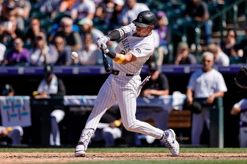 Sep 1, 2024; Denver, Colorado, USA; Colorado Rockies designated hitter Nolan Jones (22) hits an RBI single in the seventh inning against the Baltimore Orioles at Coors Field. Mandatory Credit: Isaiah J. Downing-USA TODAY Sports
