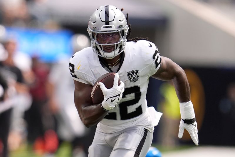 Las Vegas Raiders running back Alexander Mattison (22) runs for a touchdown against the Los Angeles Chargers during the first half of an NFL football game, Sunday, Sept. 8, 2024, in Inglewood, Calif. (AP Photo/Marcio Jose Sanchez)