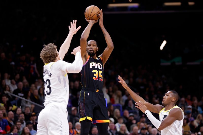 PHOENIX, ARIZONA - FEBRUARY 08: Kevin Durant #35 of the Phoenix Suns shoots over Lauri Markkanen (L) #23 of the Utah Jazz and Kris Dunn #11 during the first half at Footprint Center on February 08, 2024 in Phoenix, Arizona. NOTE TO USER: User expressly acknowledges and agrees that, by downloading and or using this photograph, User is consenting to the terms and conditions of the Getty Images License Agreement.  (Photo by Chris Coduto/Getty Images)