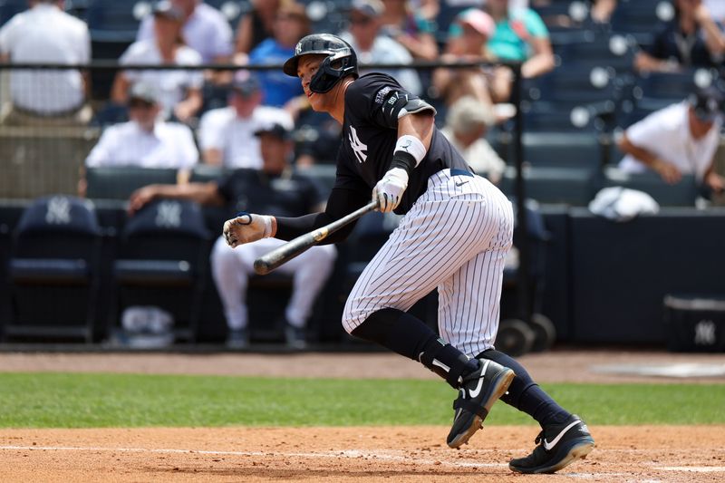 Mar 25, 2024; Tampa, Florida, USA;  New York Yankees center fielder Aaron Judge (99) hits a base hit against the New York Mets in the seventh inning at George M. Steinbrenner Field. Mandatory Credit: Nathan Ray Seebeck-USA TODAY Sports