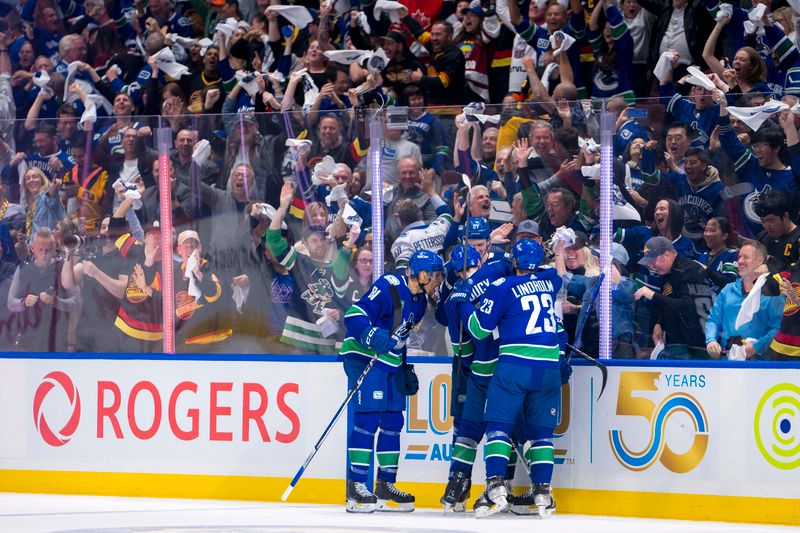 May 8, 2024; Vancouver, British Columbia, CAN; Vancouver Canucks forward Dakota Joshua (81) and defenseman Carson Soucy (7) and forward Conor Garland (8) and defenseman Tyler Myers (57) and forward Elias Lindholm (23) celebrate Garland’s game winning goal against the Edmonton Oilers during the third period in game one of the second round of the 2024 Stanley Cup Playoffs at Rogers Arena. Mandatory Credit: Bob Frid-USA TODAY Sports