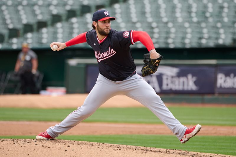 Apr 14, 2024; Oakland, California, USA; Washington Nationals starting pitcher Trevor Williams (32) throws a pitch against the Oakland Athletics during the first inning at Oakland-Alameda County Coliseum. Mandatory Credit: Robert Edwards-USA TODAY Sports