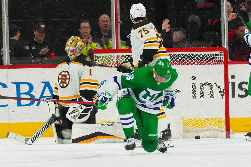 Mar 26, 2023; Raleigh, North Carolina, USA;  Carolina Hurricanes center Jack Drury (18) scores a goal past Boston Bruins goaltender Jeremy Swayman (1) during the second period at PNC Arena. Mandatory Credit: James Guillory-USA TODAY Sports