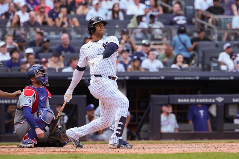 Aug 11, 2024; Bronx, New York, USA; New York Yankees right fielder Juan Soto (22) hits a solo home run during the seventh inning against the Texas Rangers at Yankee Stadium. Mandatory Credit: Vincent Carchietta-USA TODAY Sports