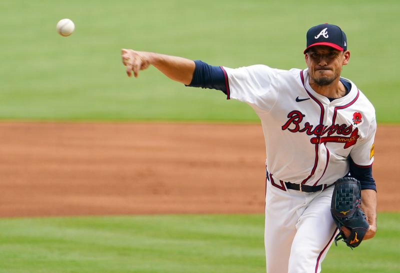 May 27, 2024; Cumberland, Georgia, USA; Atlanta Braves pitcher Charlie Morton (50) fires off a pitch against the Washington Nationals during the first inning at Truist Park. Mandatory Credit: John David Mercer-USA TODAY Sports