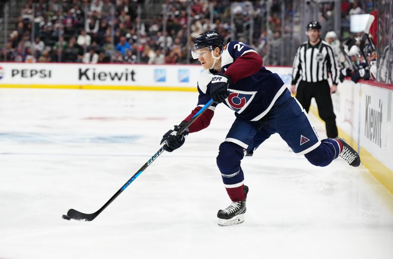 Apr 7, 2024; Denver, Colorado, USA; Colorado Avalanche center Nathan MacKinnon (29) shoots the puck in the second period against the Dallas Stars at Ball Arena. Mandatory Credit: Ron Chenoy-USA TODAY Sports