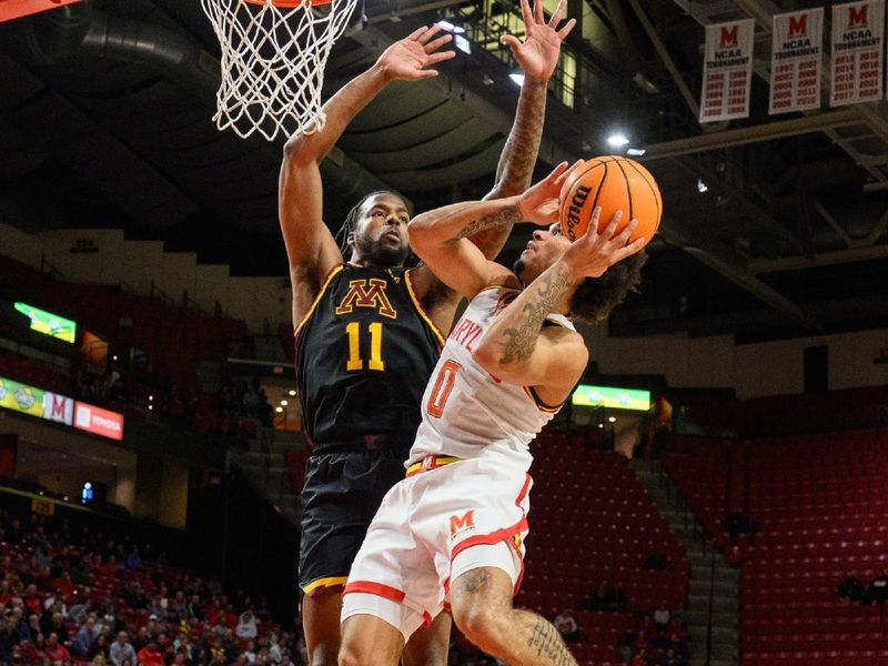 Jan 13, 2025; College Park, Maryland, USA; Maryland Terrapins guard Ja'Kobi Gillespie (0) takes a shot over Minnesota Golden Gophers guard Femi Odukale (11) during the second half at Xfinity Center. Mandatory Credit: Reggie Hildred-Imagn Images